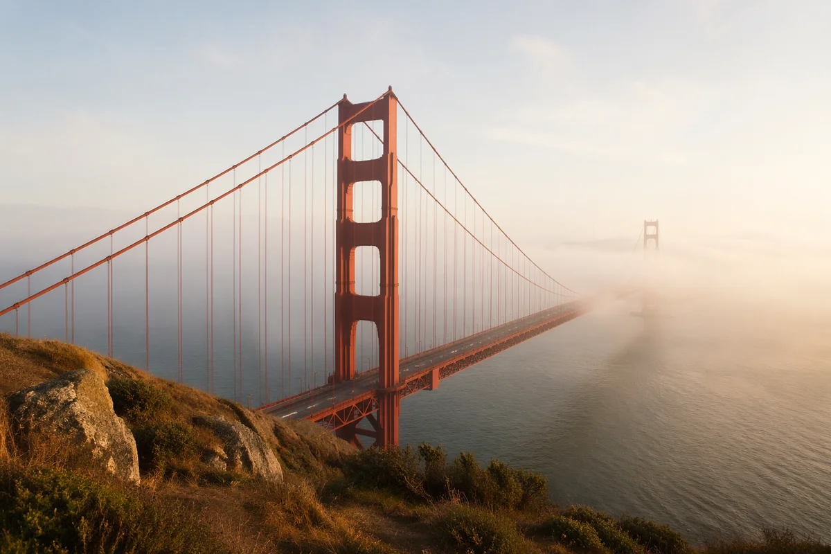 Foggy Vermilion Suspension Bridge at Dawn
