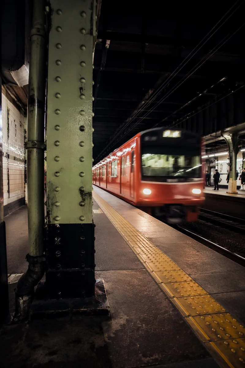 Night Commuter Train Arriving at Urban Platform