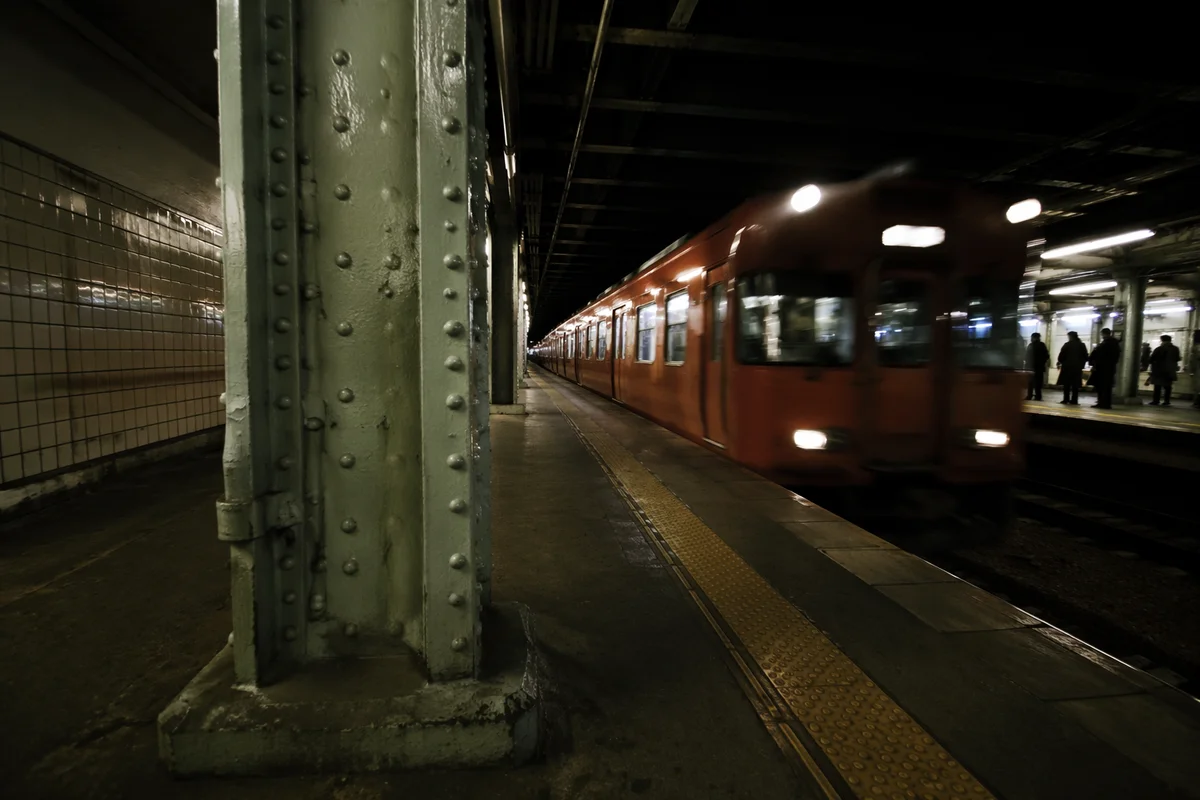 Night Commuter Train Arriving at Urban Platform