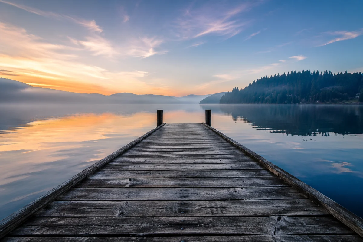 Wooden Dock at Calm Sunrise Lake