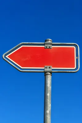 Blank Red Arrow Sign Under Blue Sky