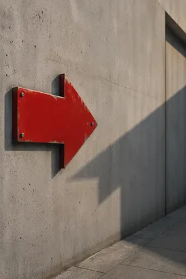 Red Arrow Sign on Concrete Wall