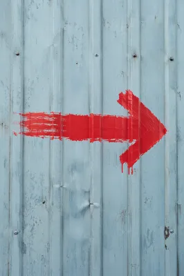 Red Arrow on Blue Metal Wall