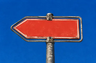 Blank Red Arrow Sign Under Blue Sky