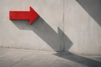 Red Arrow Sign on Concrete Wall