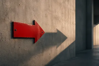 Red Arrow Sign on Concrete Wall