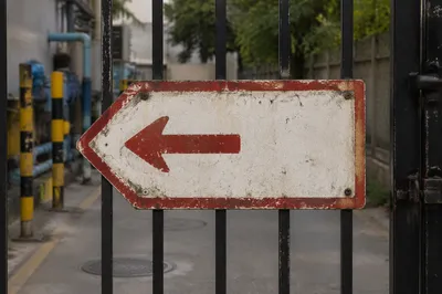Weathered Red Arrow Direction Sign