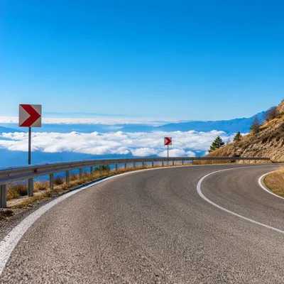 Red Arrow Signs on Mountain Road Curve