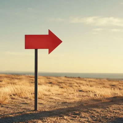 Red Arrow Sign in Minimal Desert Landscape