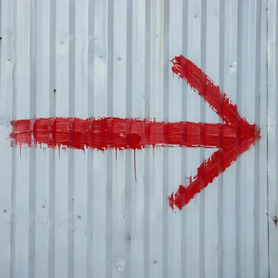Red Arrow on Blue Gray Metal