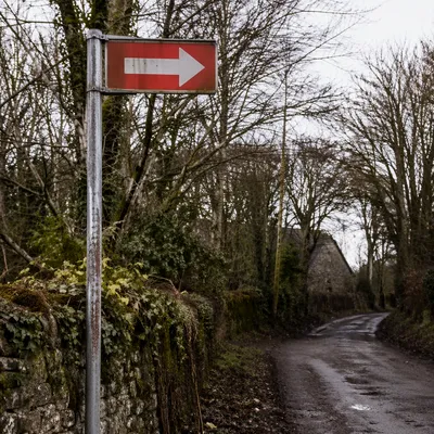 Red Arrow Sign on Rural Winter Road