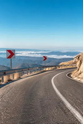 Red Arrow Signs on Mountain Road Curve