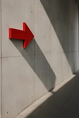 Red Arrow Sign on Concrete Wall