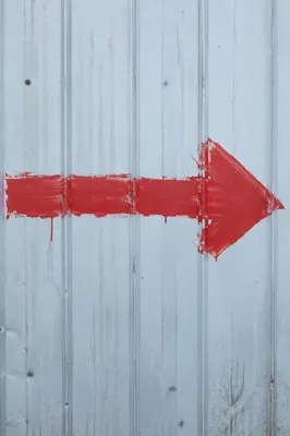 Red Arrow on Blue Metal Wall