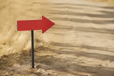 Red Arrow Sign in Minimal Desert Landscape