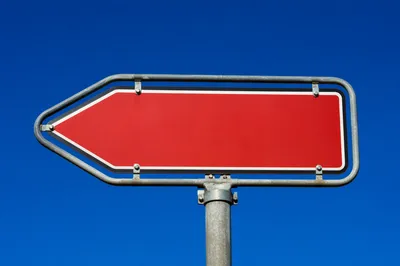 Red Left Arrow Sign Under Blue Sky