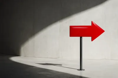 Red Arrow Sign in Minimal Concrete Space