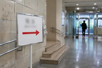 Red Arrow Direction Sign in Modern Corridor
