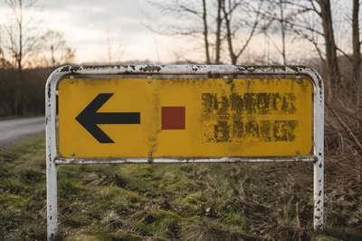 Weathered Yellow Sign with Red Direction Marker