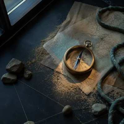 Brass Compass on Abstract Dawn Map