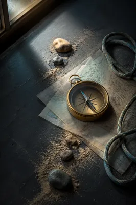 Brass Compass on Abstract Map Layers