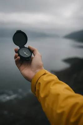 Hand Holding Compass in Misty Dawn