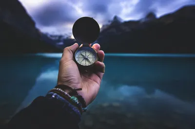 Compass in Hand by Twilight Mountain Lake