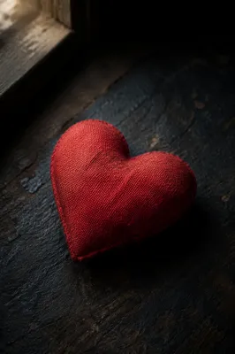 Crimson Fabric Heart on Dark Textured Surface