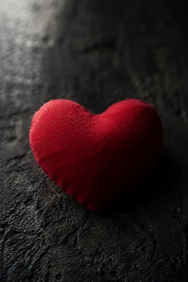Red Heart Cushion on Dark Surface