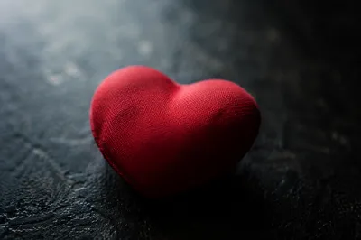 Red Heart Cushion on Dark Textured Surface