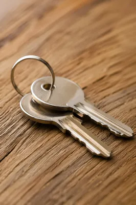 Silver Keys on Warm Wooden Tabletop