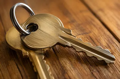 Overlapping Metal Keys on Wooden Table