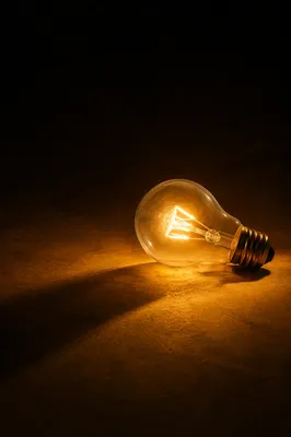Glowing Light Bulb in Quiet Darkness
