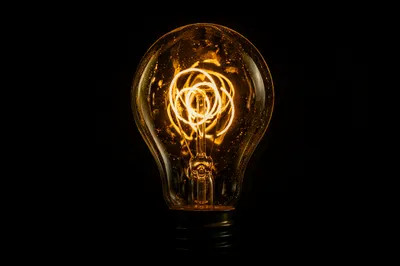Glowing Light Bulb Idea in Darkness