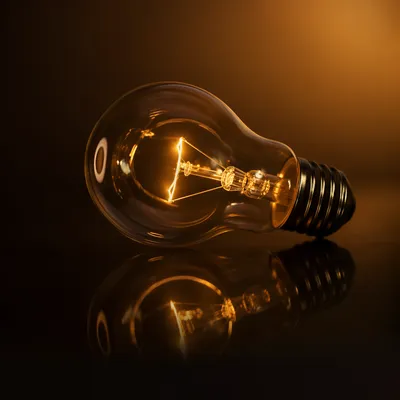 Glowing Light Bulb Idea on Dark Reflection