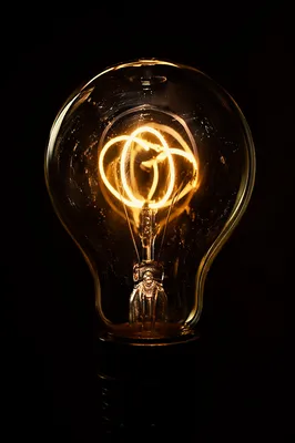 Glowing Light Bulb Idea in Darkness