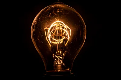 Glowing Light Bulb Idea in Darkness