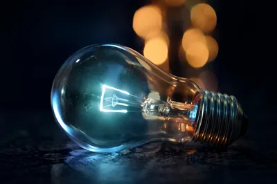 Glowing Light Bulb Idea on Dark Surface