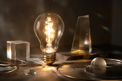 Glowing Light Bulb on Charcoal Table