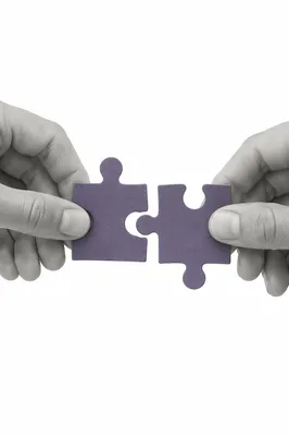 Purple Puzzle Pieces Symbolizing Teamwork
