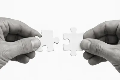 White Puzzle Pieces Symbolizing Teamwork Connection
