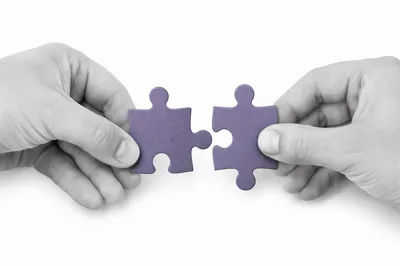 Purple Puzzle Pieces Symbolizing Teamwork