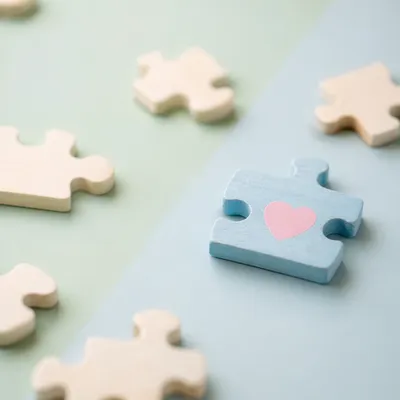 Wooden Puzzle Pieces Symbolizing Teamwork Connection