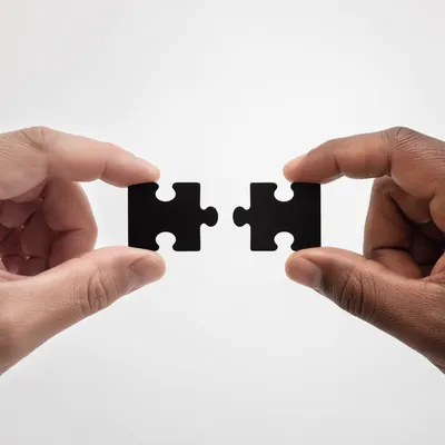 Hands Connecting Puzzle Pieces for Teamwork