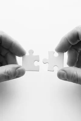 Hands Connecting Puzzle Pieces for Teamwork