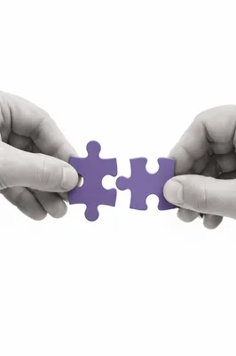 Purple Puzzle Pieces Joining in Teamwork