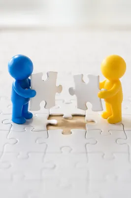 Teamwork Puzzle Connection with Blue and Yellow Figures