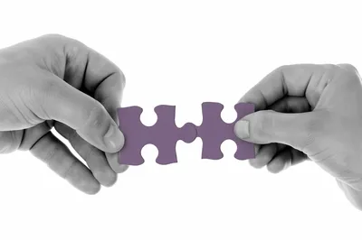 Purple Puzzle Pieces Symbolizing Teamwork