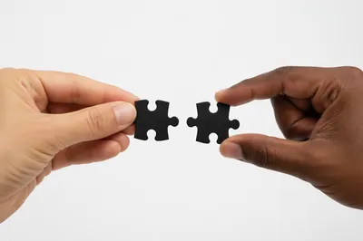 Hands Connecting Puzzle Pieces for Teamwork