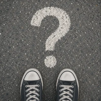Question Mark on Asphalt Before Sneakers